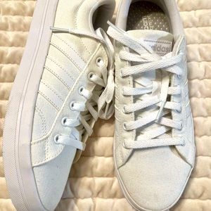White canvas adidas womens shoe never worn. Bought wrong size.